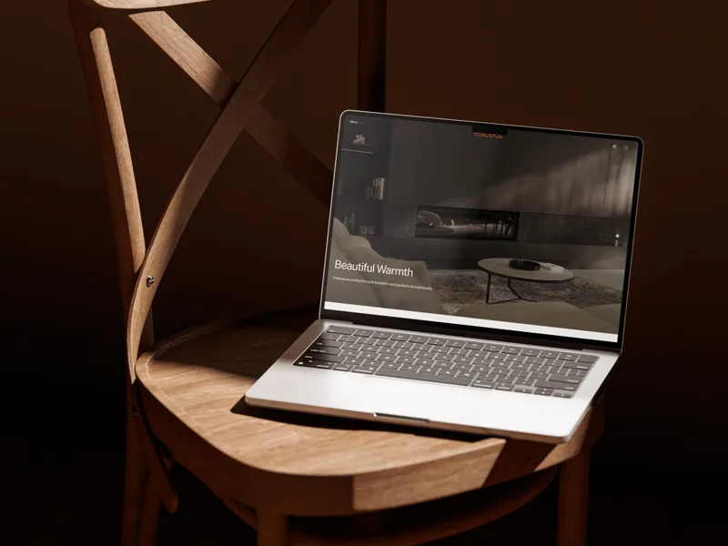 The Escea website on a laptop on a wooden chair